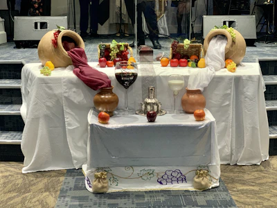 Ancient Roman feast setup featuring terracotta dishes and ornate oil lamps.