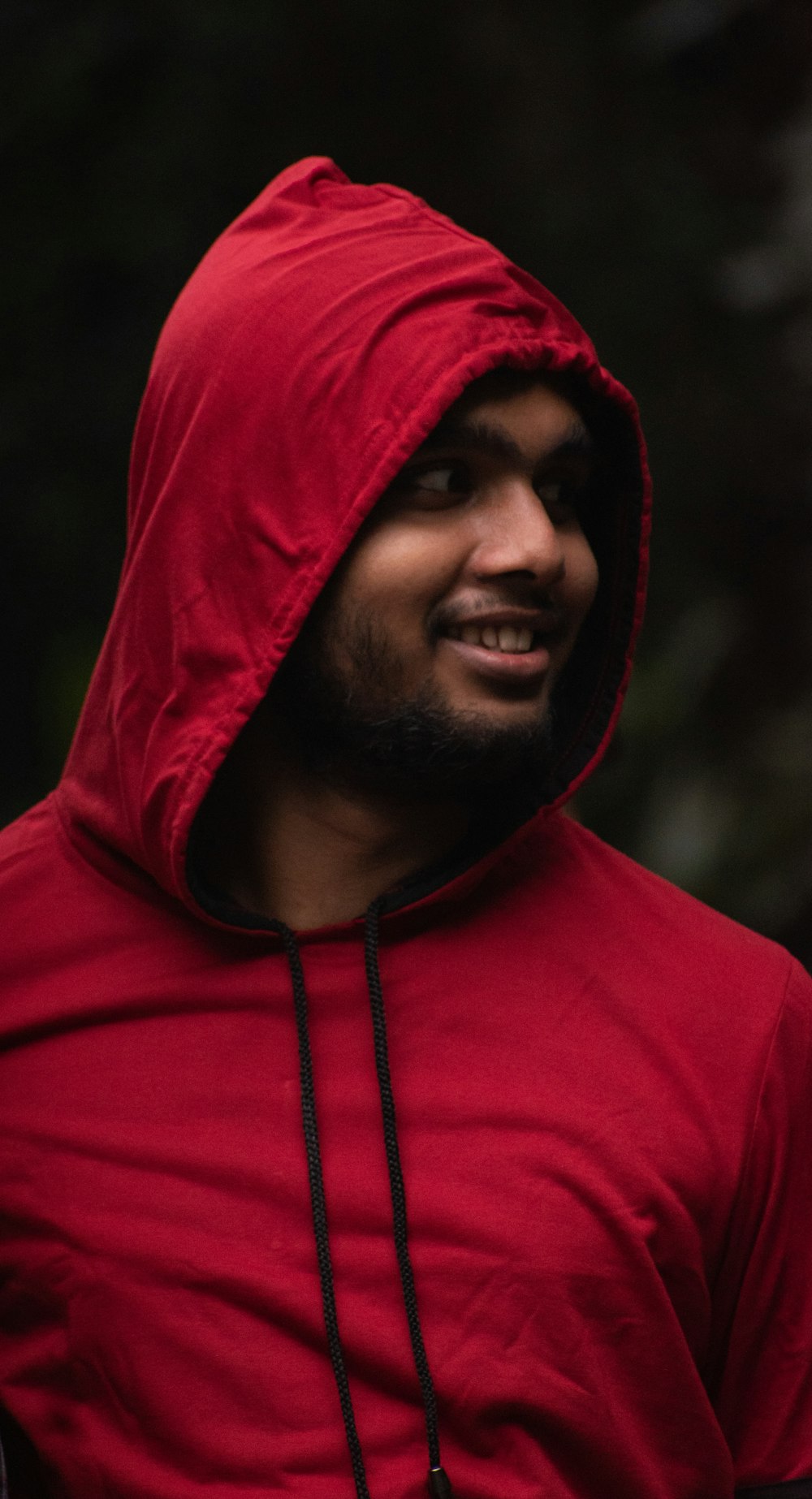 man in red hoodie smiling