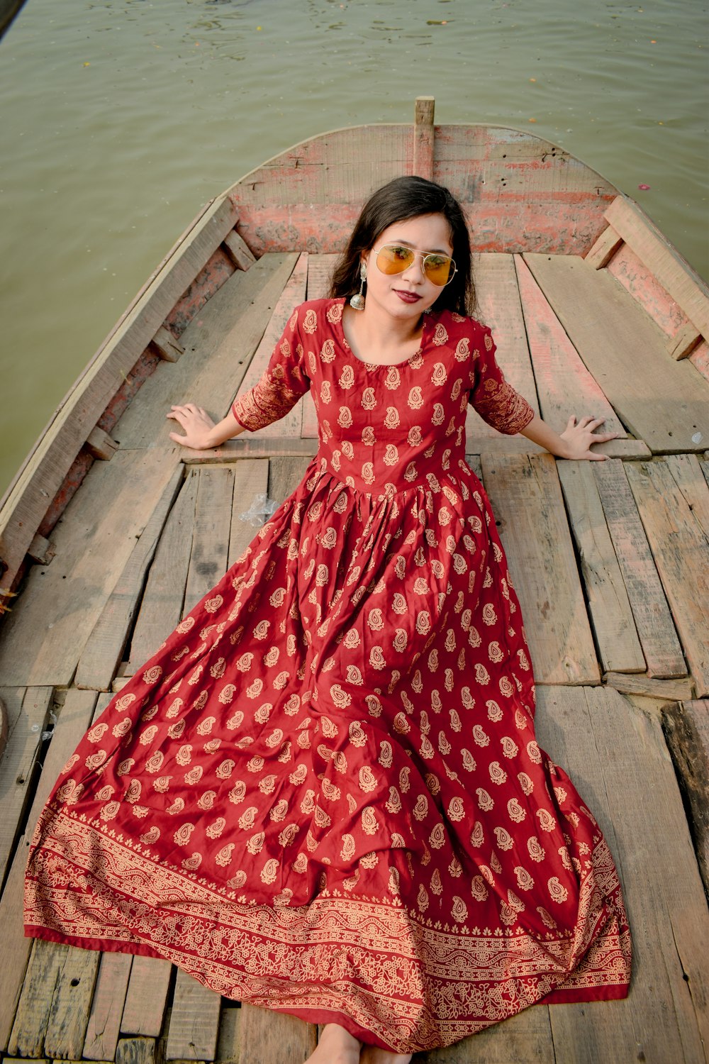 woman in red and white floral dress wearing black sunglasses