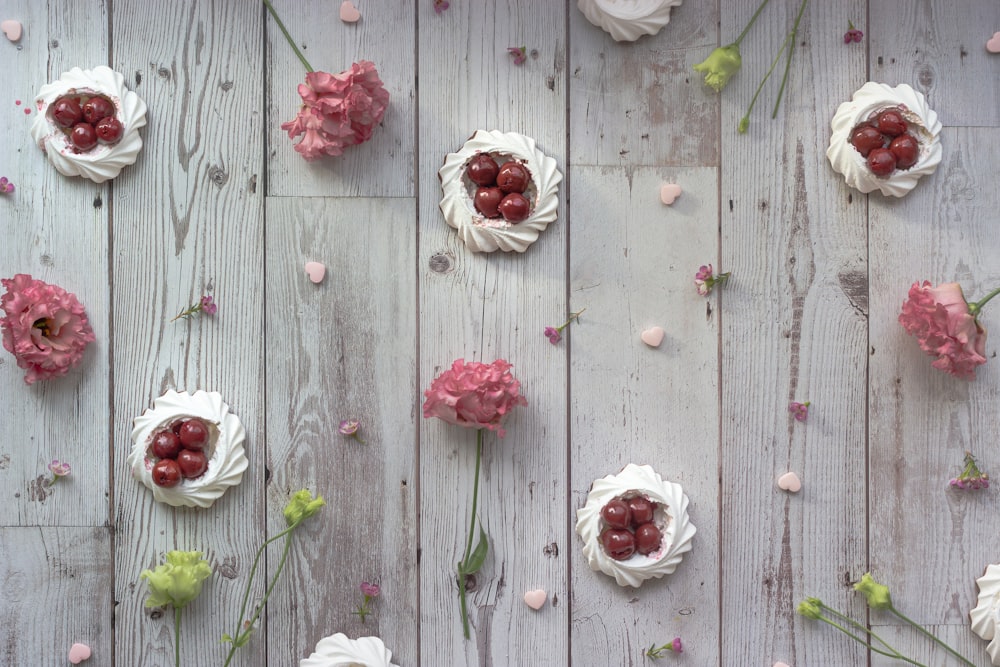 white and red roses on gray wooden surface