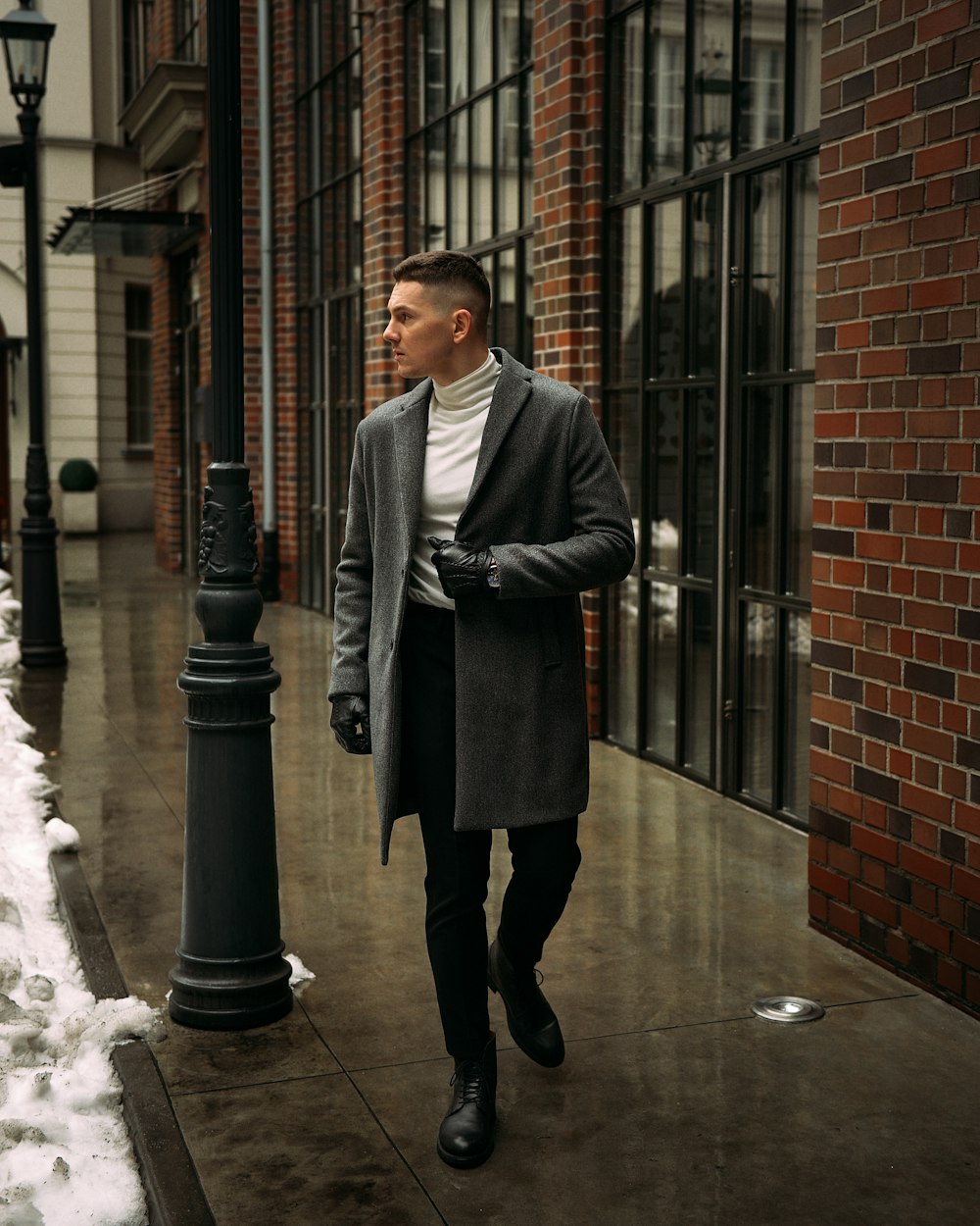 Man in black coat standing near black post photo – Free Man Image on  Unsplash