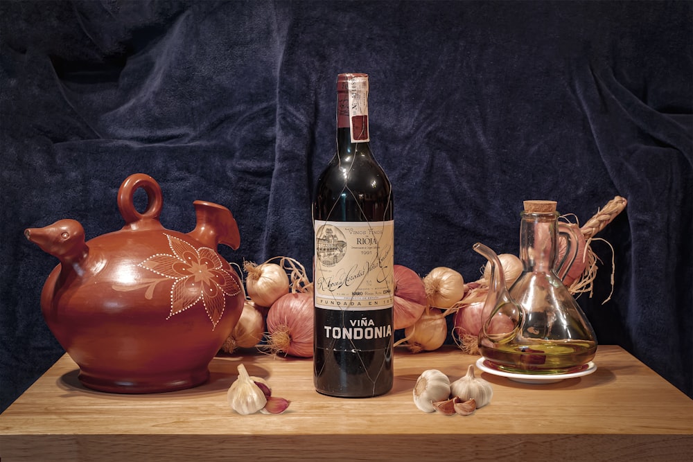 a bottle of wine sitting on top of a wooden table