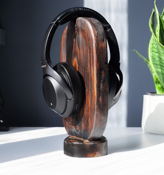 brown and black headphones on white table