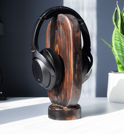 brown and black headphones on white table