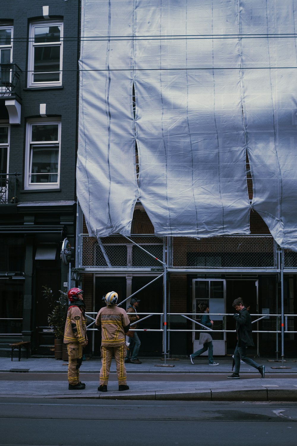 people standing in front of white building during daytime