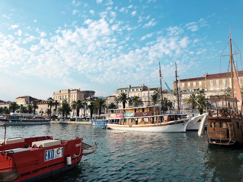 red and white boat on water near buildings during daytime