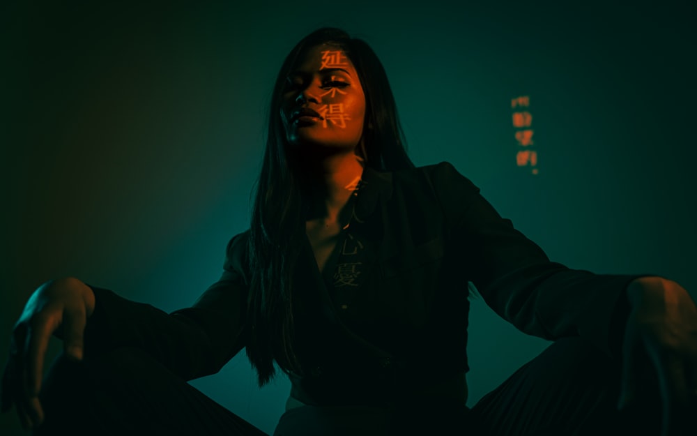 woman in black jacket sitting on chair