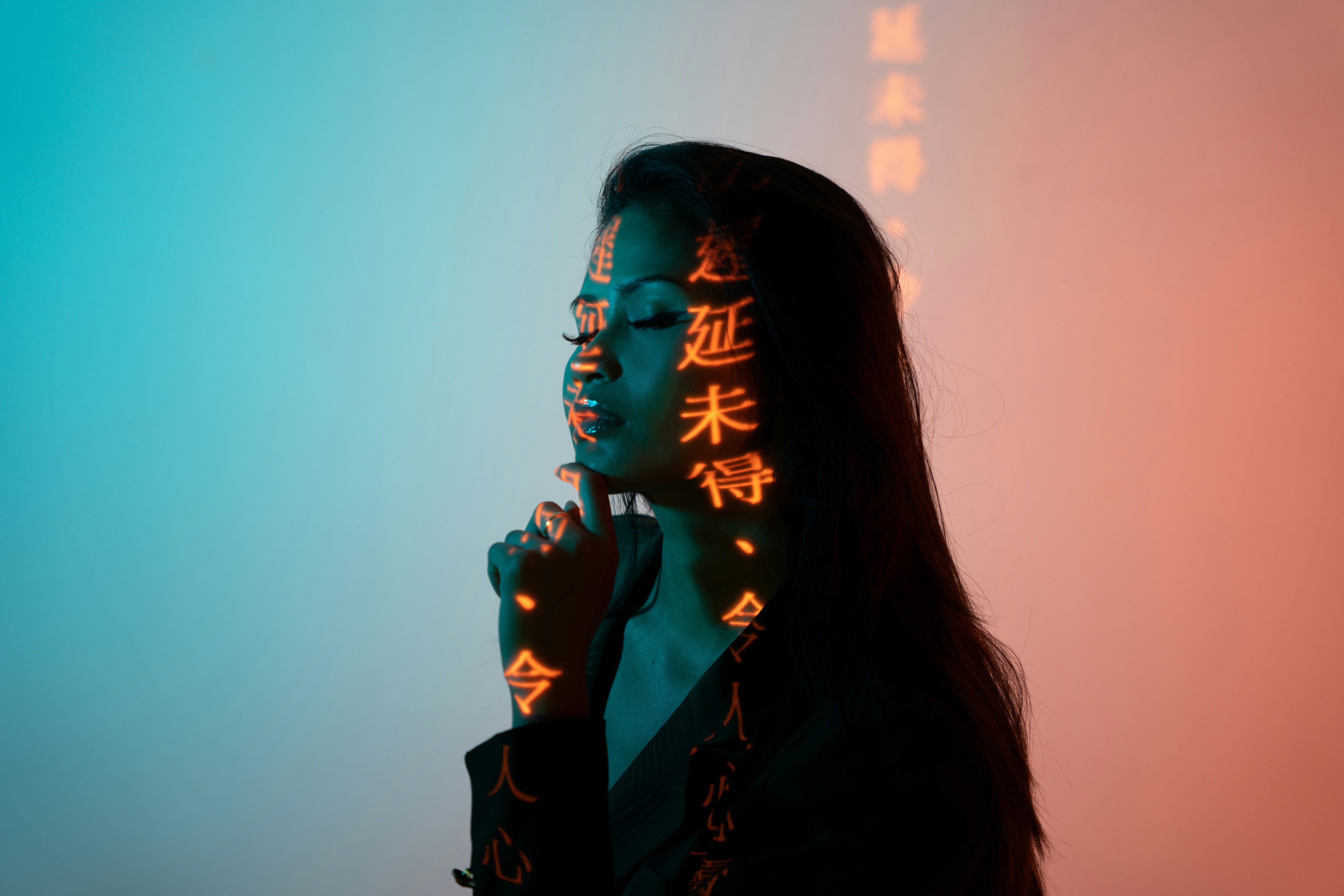 woman in black blazer with hand on chin