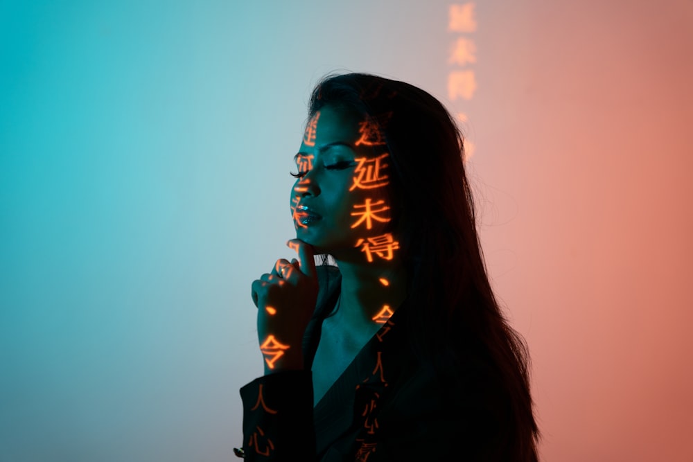 woman in black blazer with hand on chin