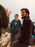 Members sharing a laugh during a casual networking break with red rock formations visible outside.