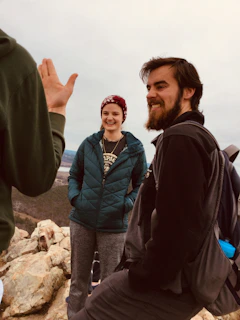 Members sharing a laugh during a casual networking break with red rock formations visible outside.