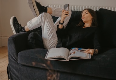 man and woman lying on black sofa