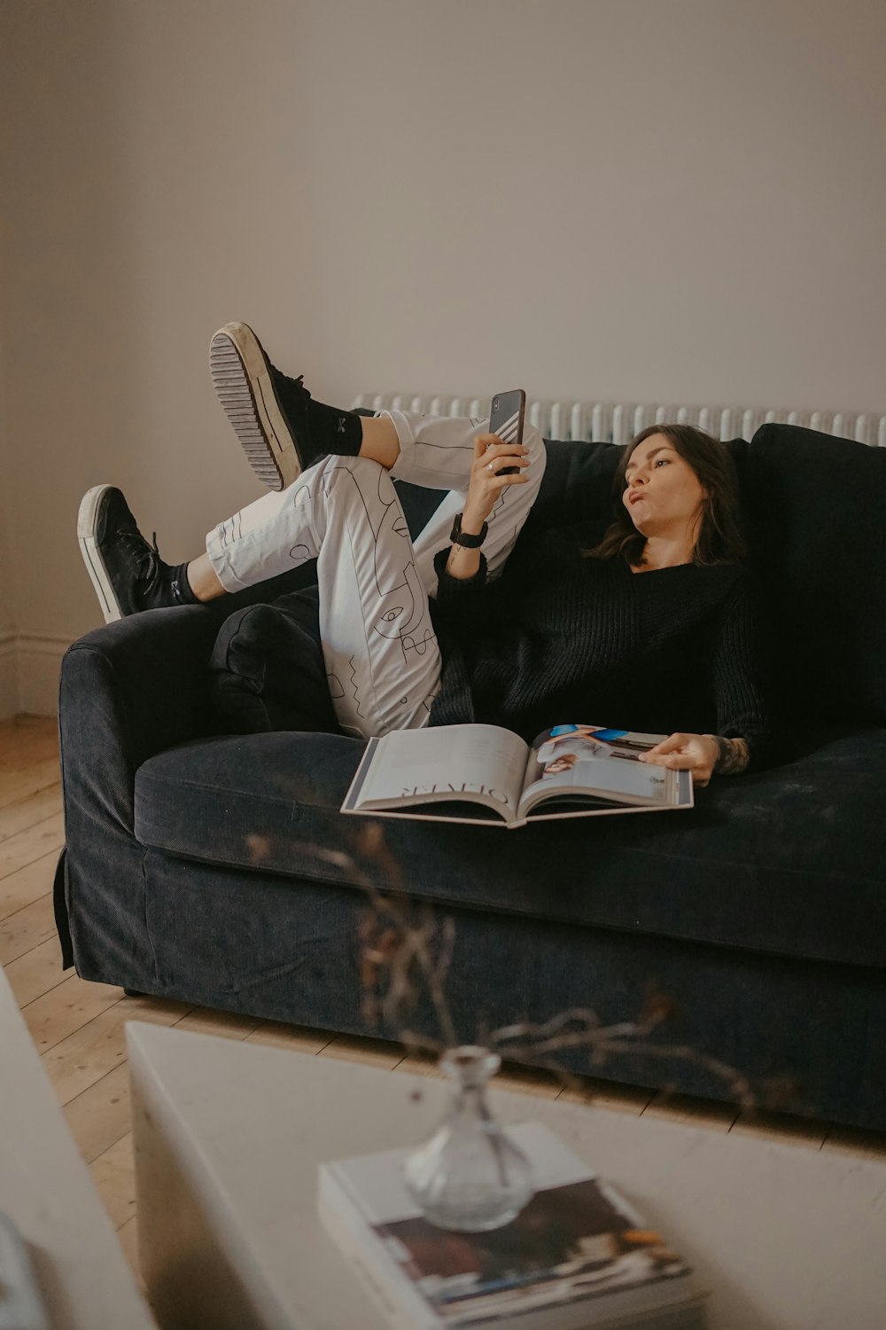 man and woman lying on black sofa