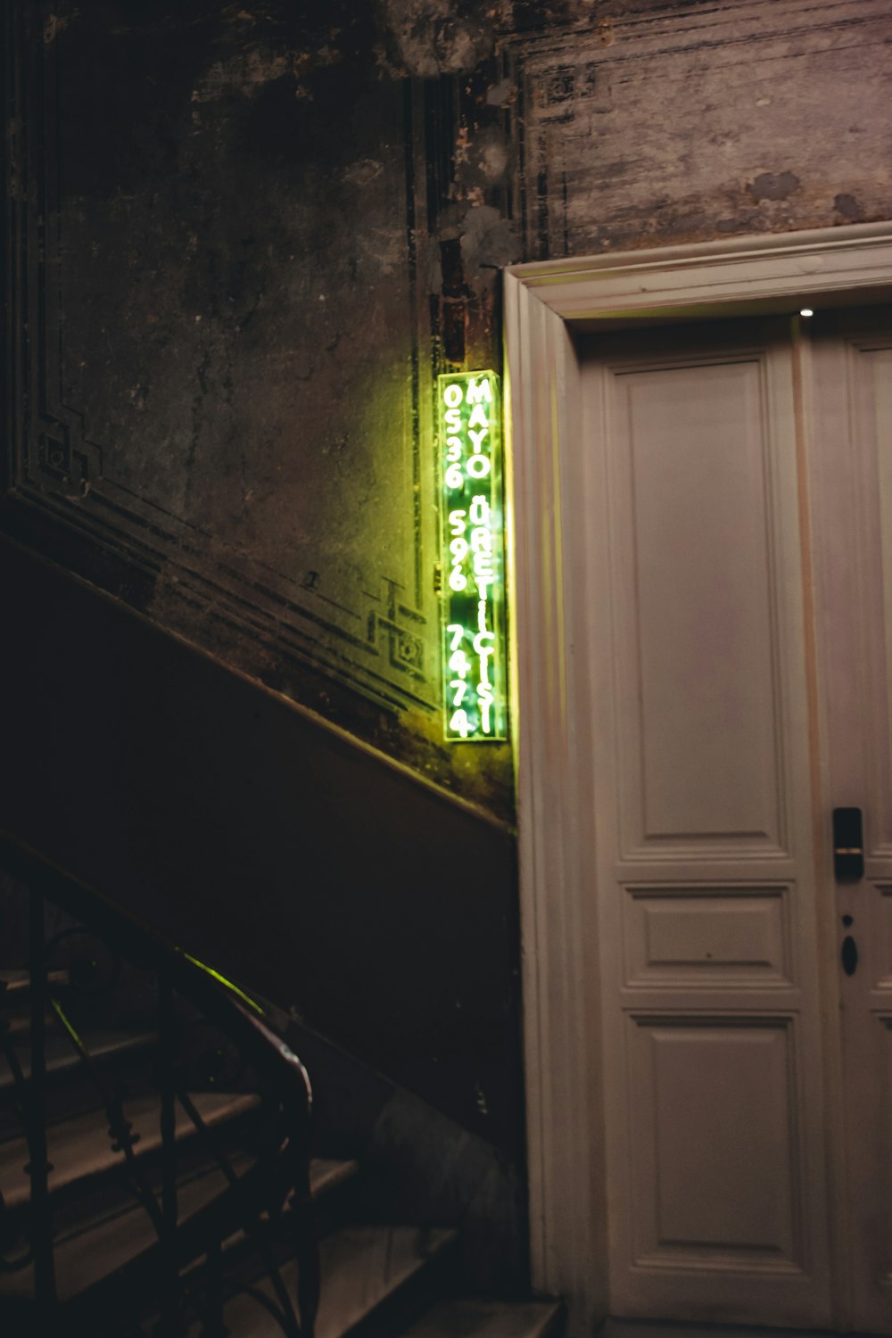 white wooden door near green window curtain