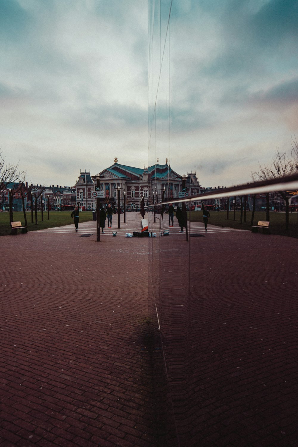 people walking on red brick pathway during daytime