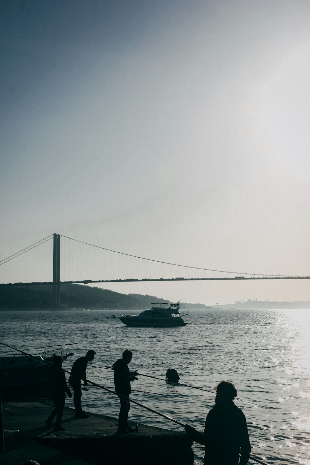 Silhouette von Menschen auf dem Boot auf See während des Tages