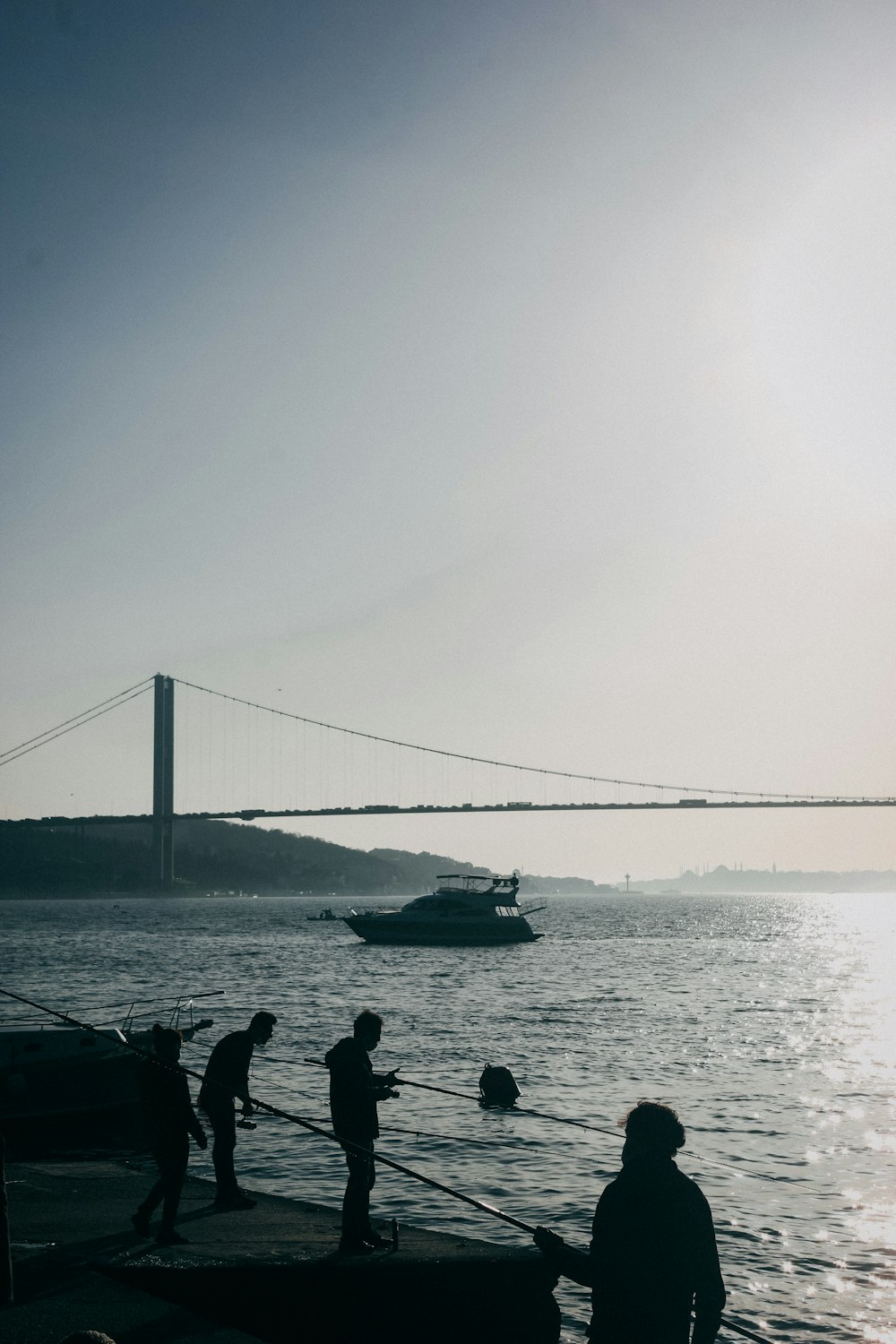 silhouette of people on boat on sea during daytime