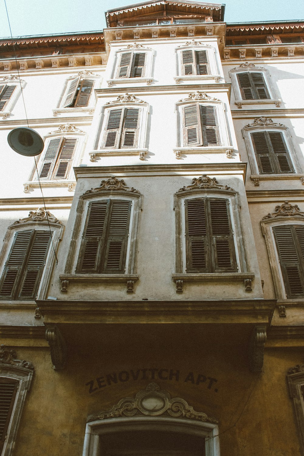 a tall building with lots of windows and shutters