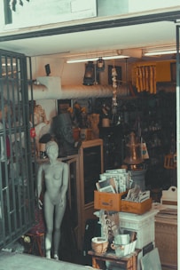 man in black jacket standing beside brown wooden table