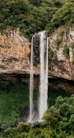 water falls on brown rocky mountain