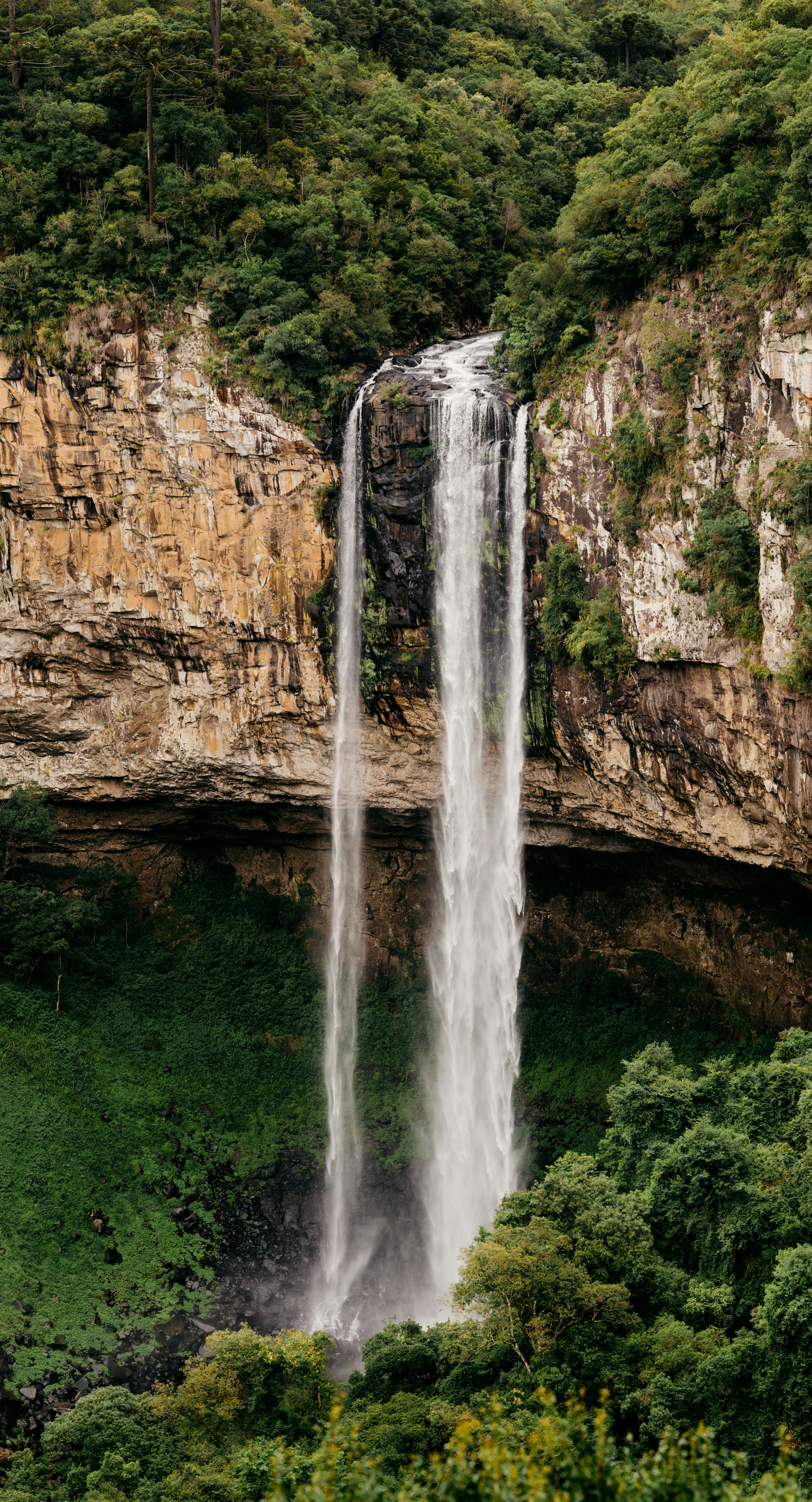 water falls on brown rocky mountain