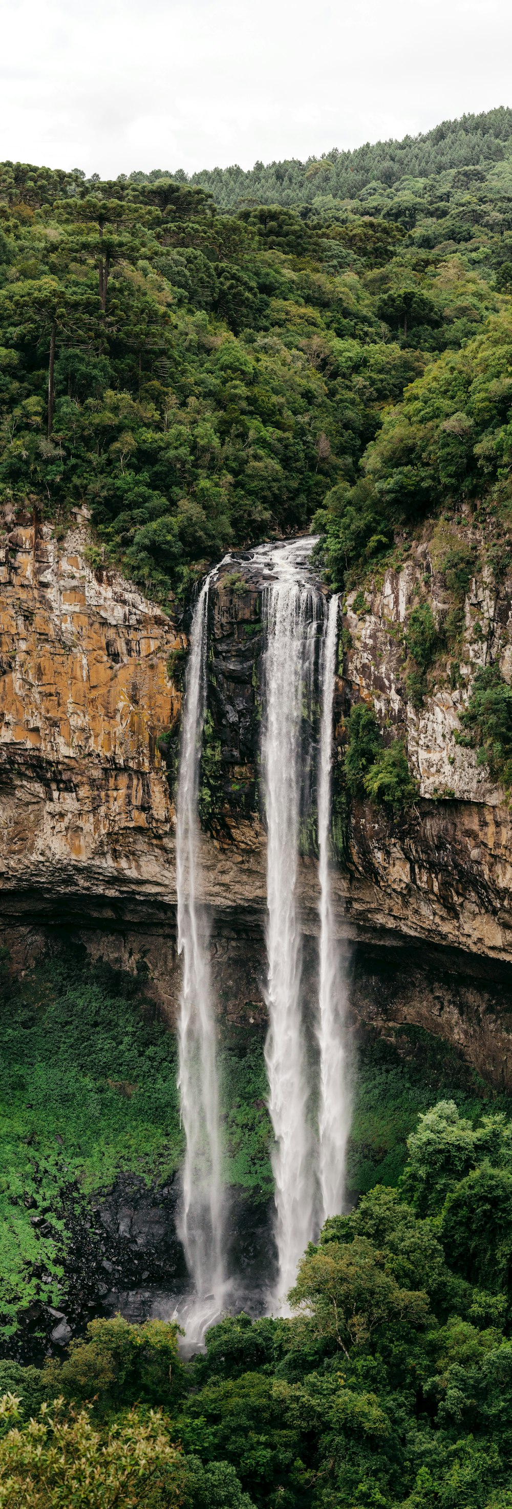 water falls on brown rocky mountain