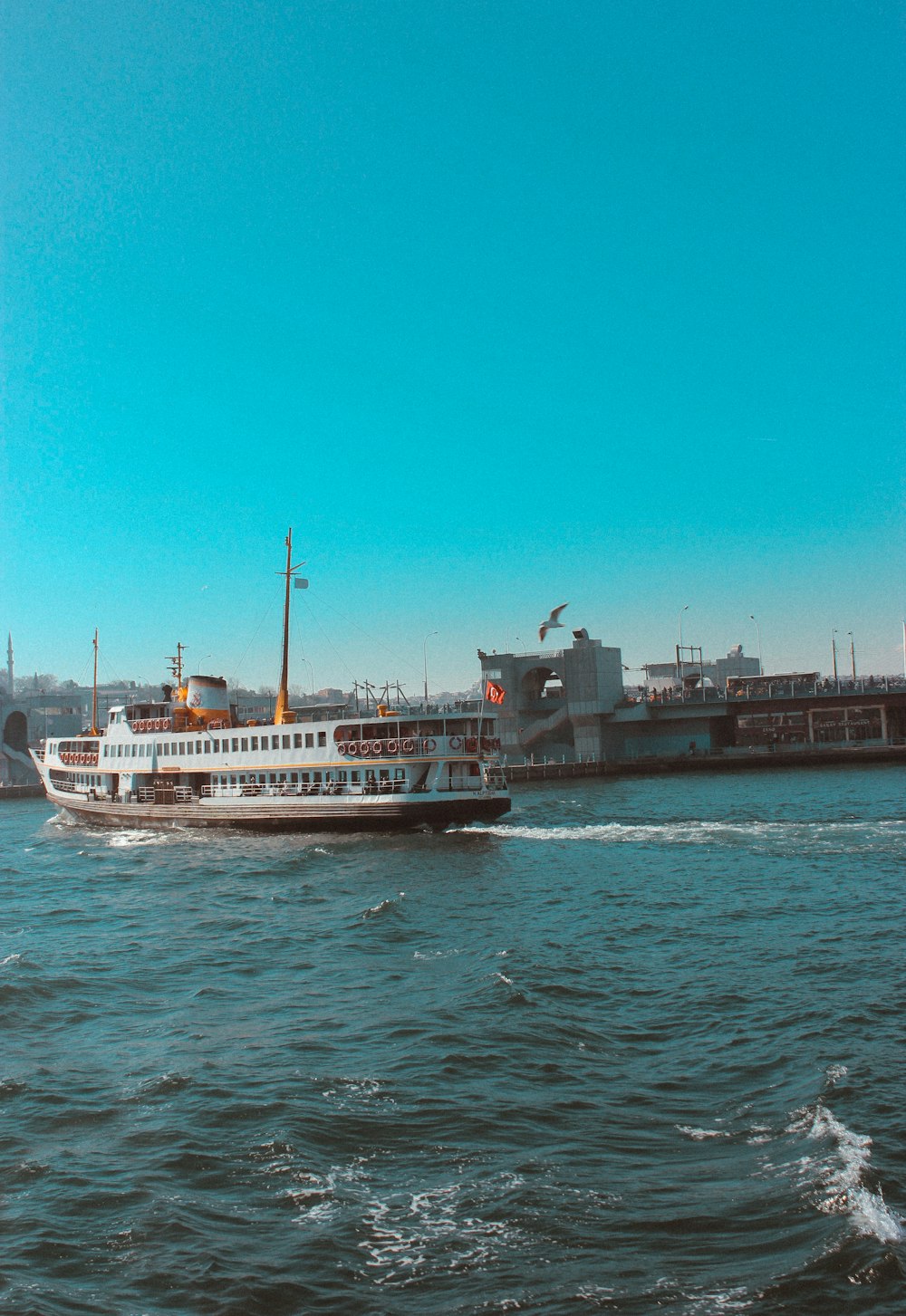 white and brown ship on sea under blue sky during daytime