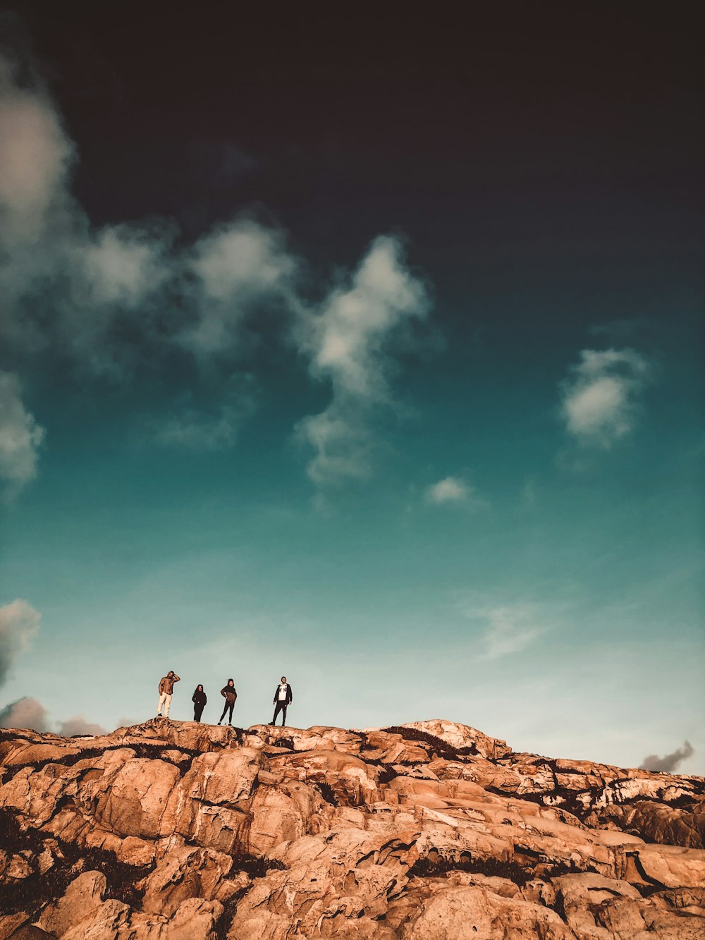 person standing on brown rock under blue sky during daytime