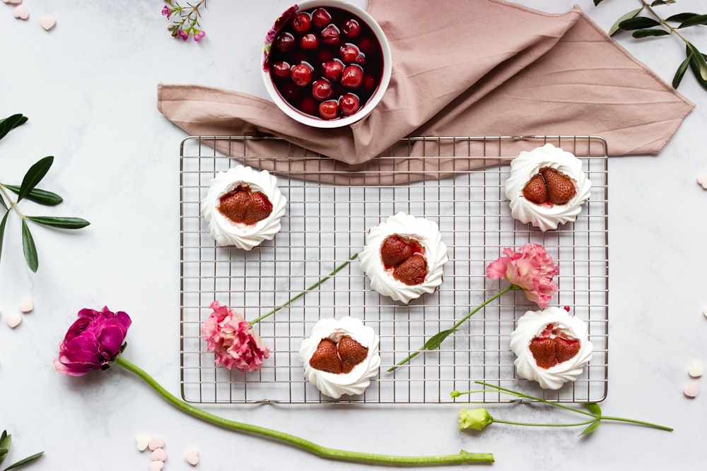 red and white round fruits on white ceramic plate