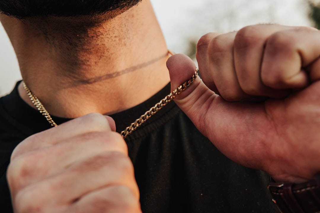 man wearing gold chain necklace