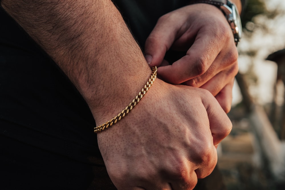 person wearing silver beaded bracelet