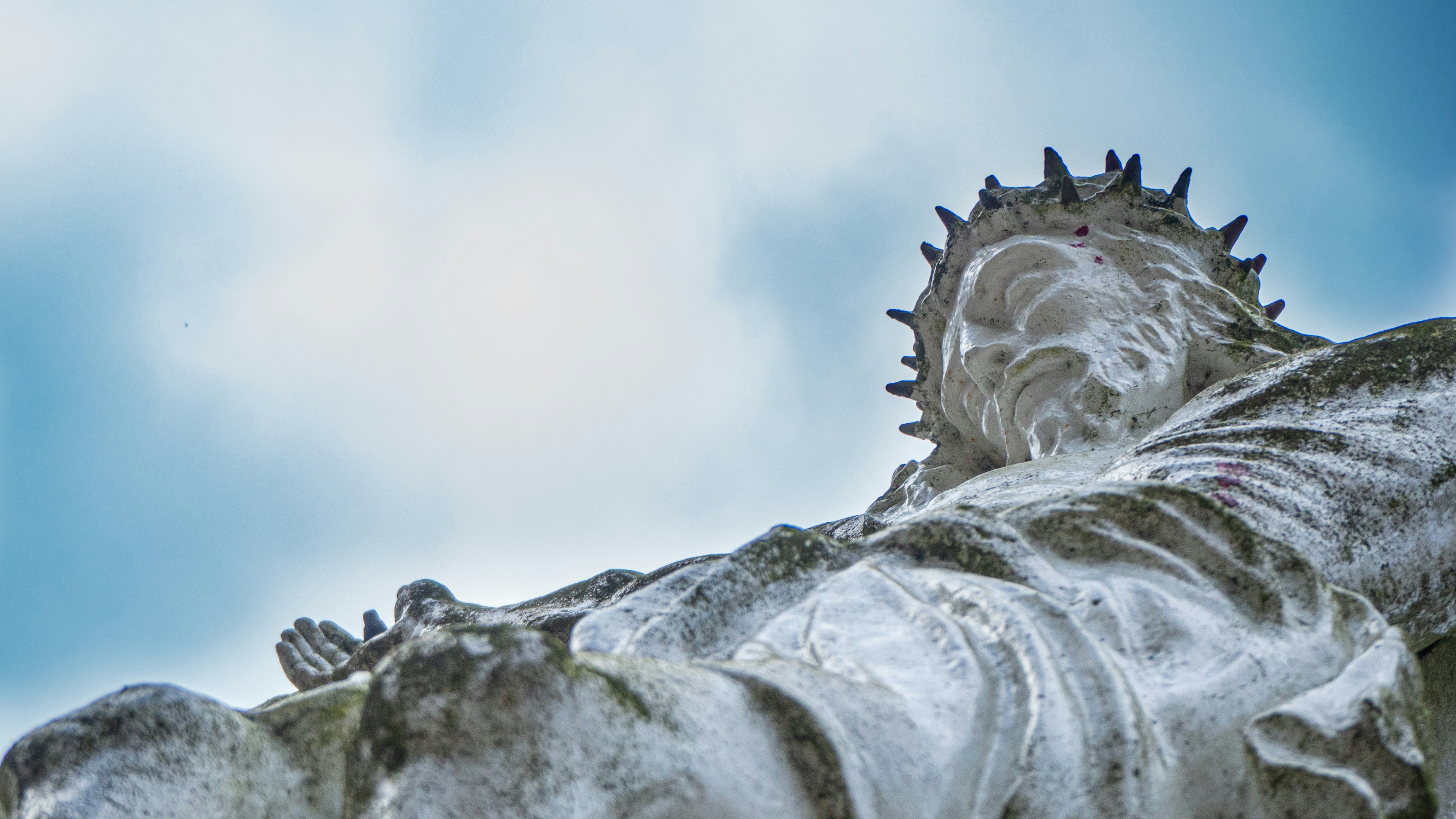 white and black stone fragment, On Good Friday we remember that Jesus died on a cross. This statue reminds us about that moment in history. I like that the statue is not cleaned.