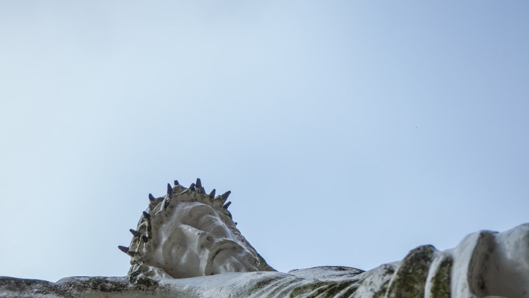 gray concrete dragon statue on white rock, On Good Friday we remember that Jesus died on a cross. This statue reminds us