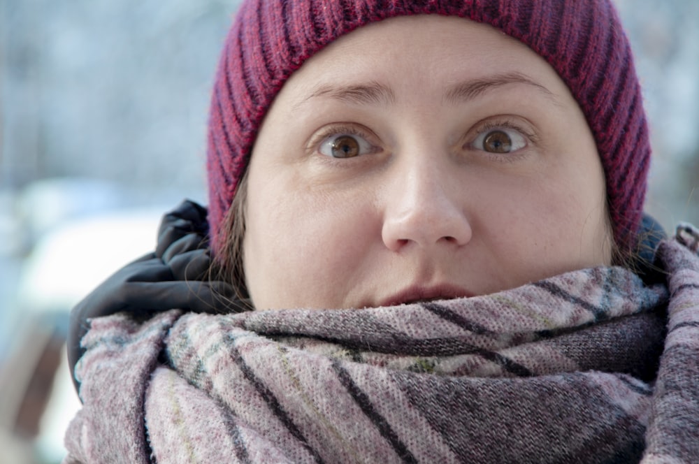 woman in gray scarf and red knit cap