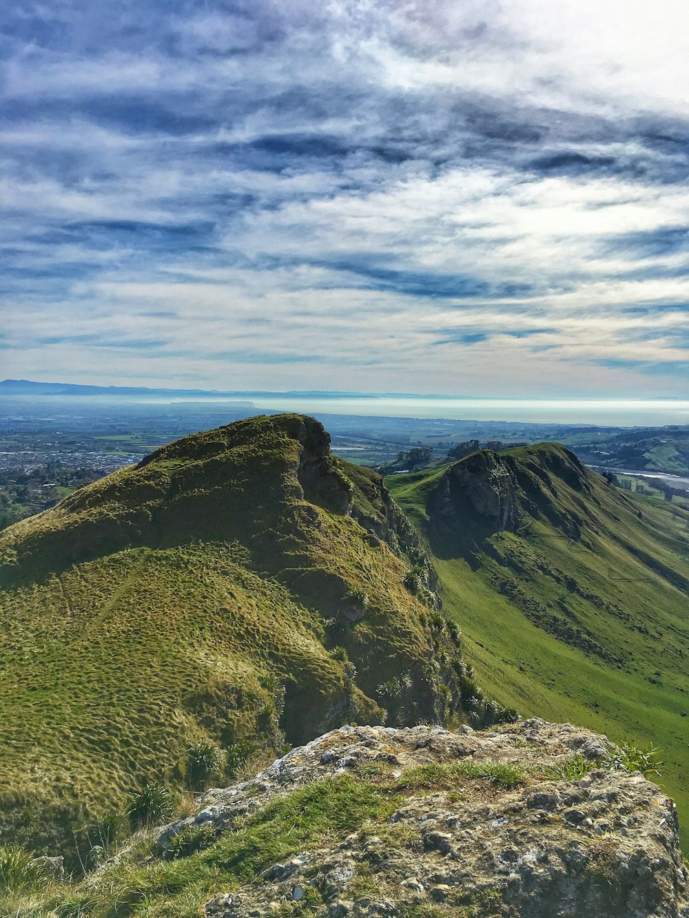 green and brown mountain under white clouds during daytime