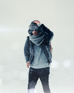 woman in black jacket and black pants standing on snow covered ground
