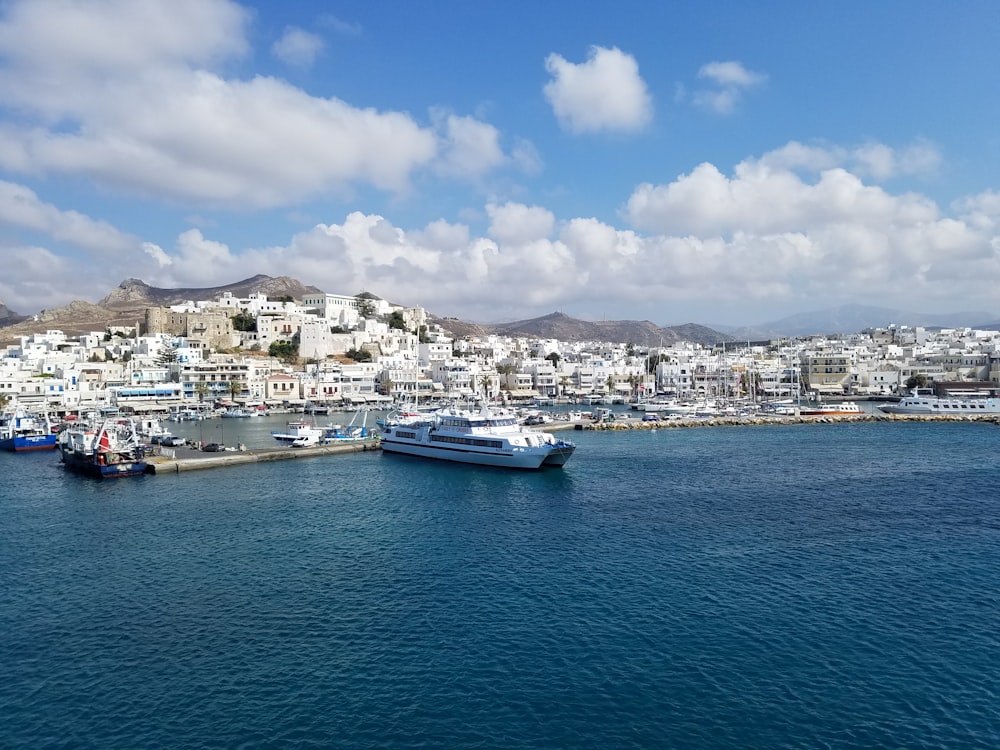 blue and white boat on sea under blue sky during daytime