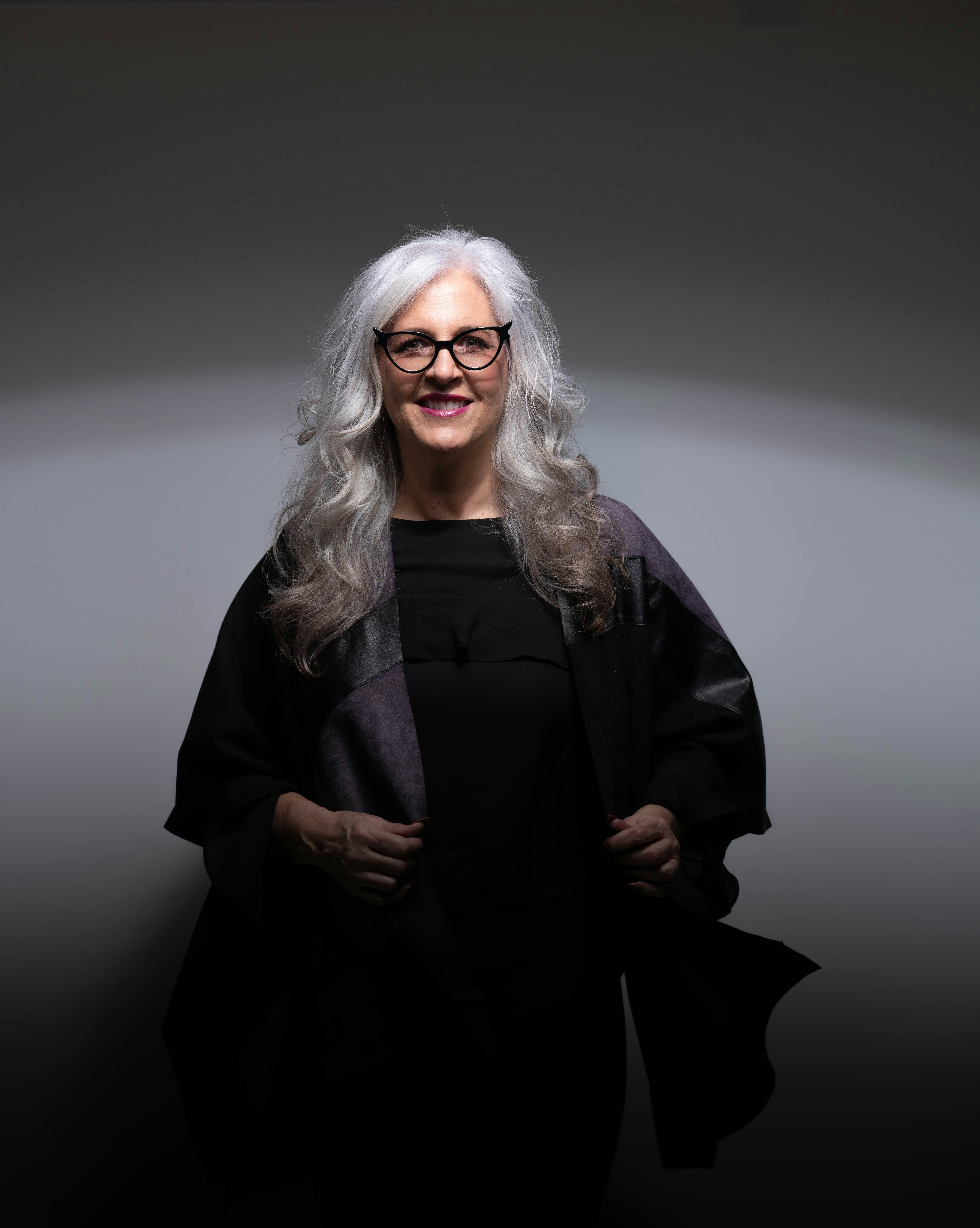 a woman over 50 with long layered gray hair