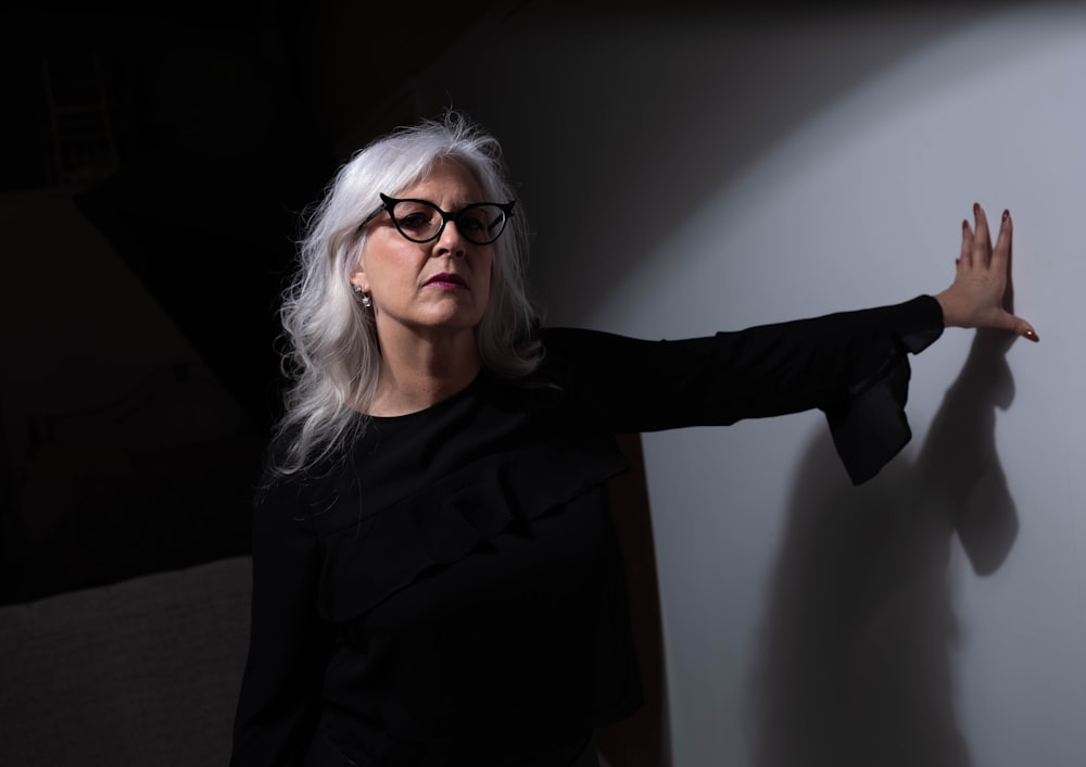 woman in black long sleeve shirt wearing eyeglasses