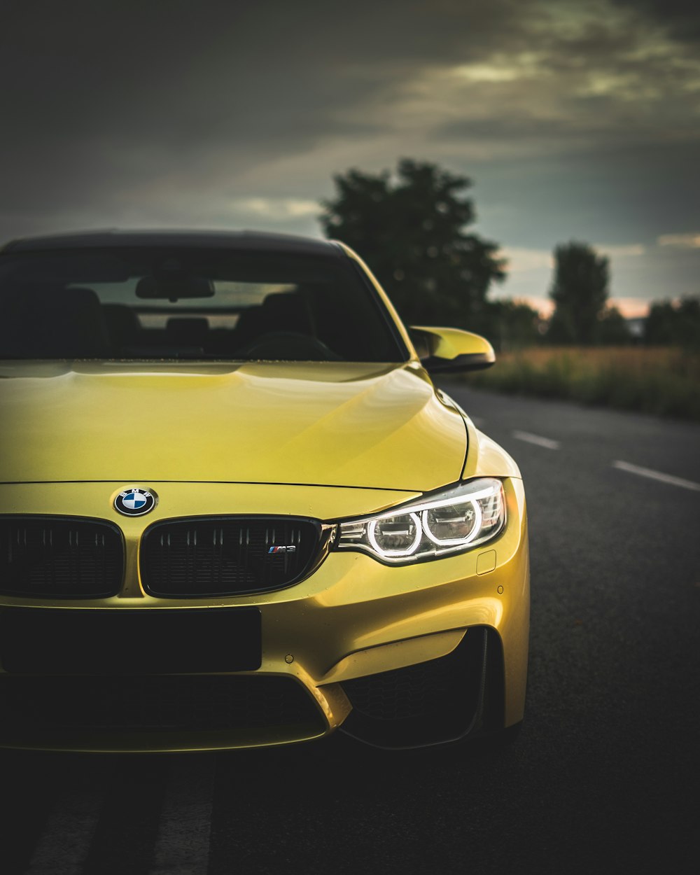 yellow bmw m 3 on road during daytime