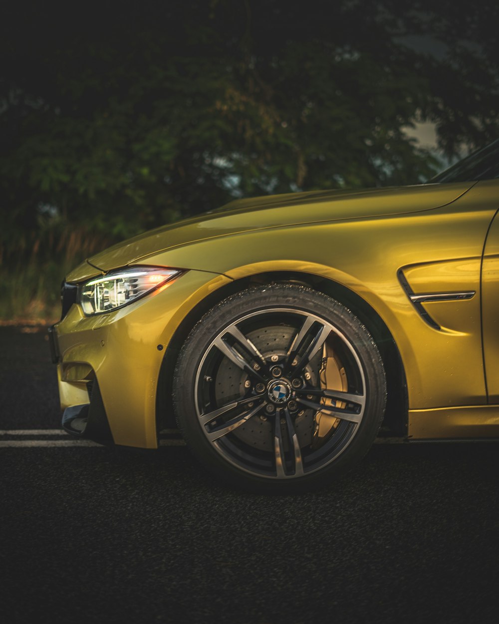 yellow car on black asphalt road during daytime