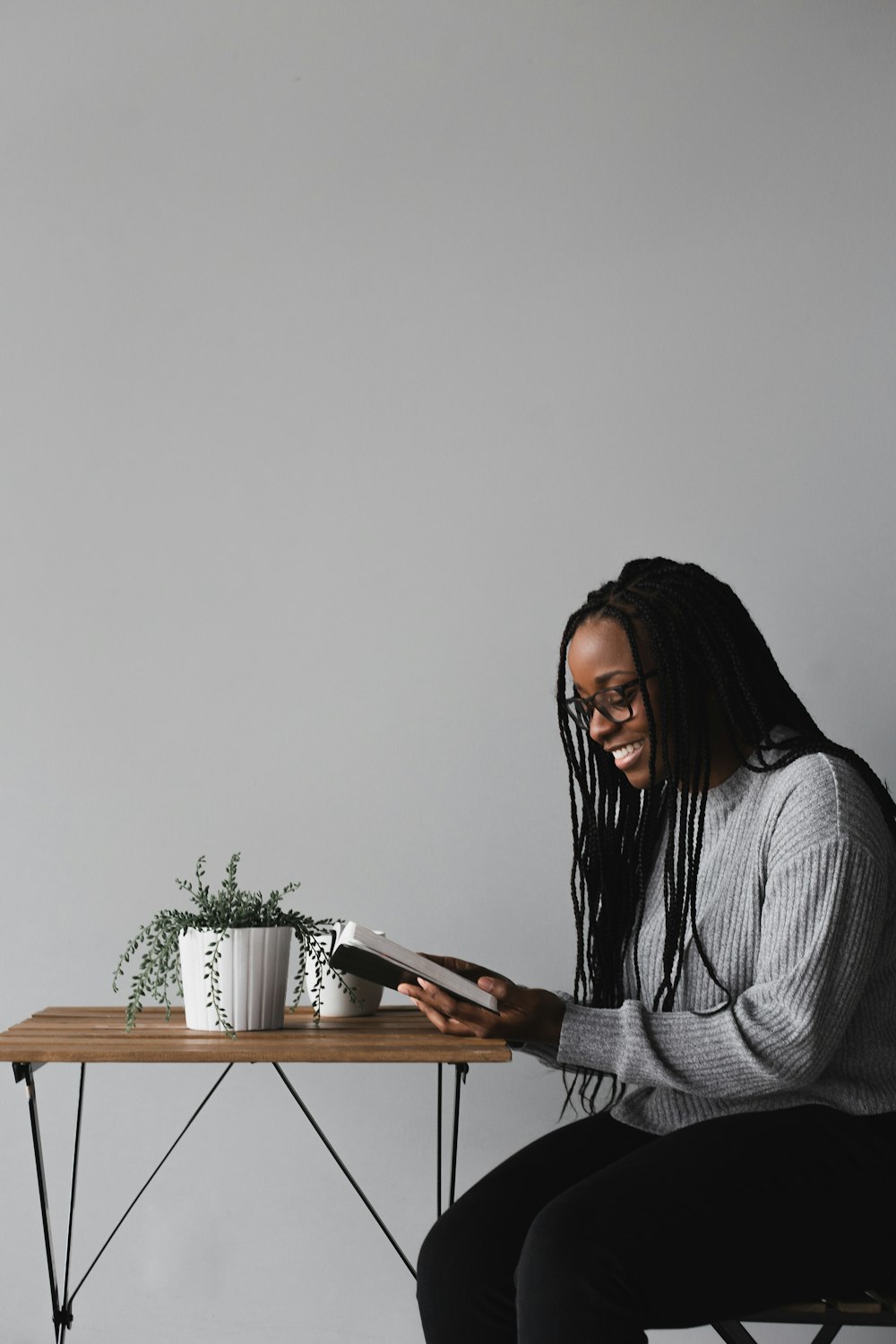 woman in white and black striped long sleeve shirt sitting on chair