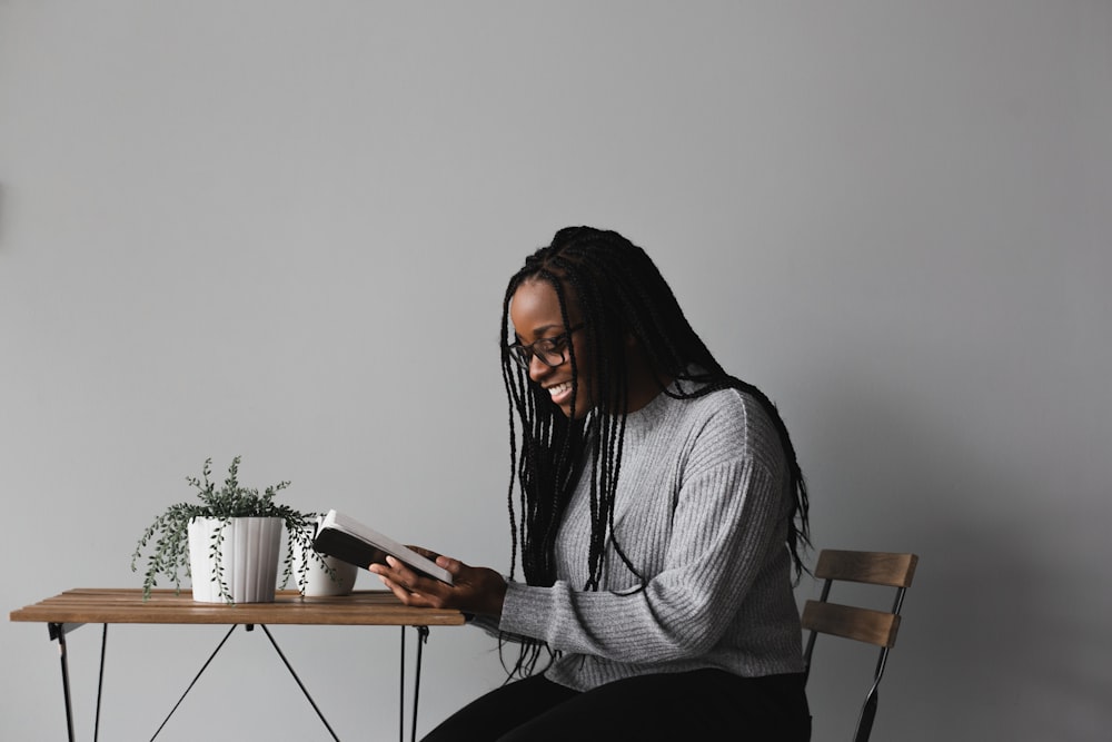 woman in white and black striped long sleeve shirt sitting on chair