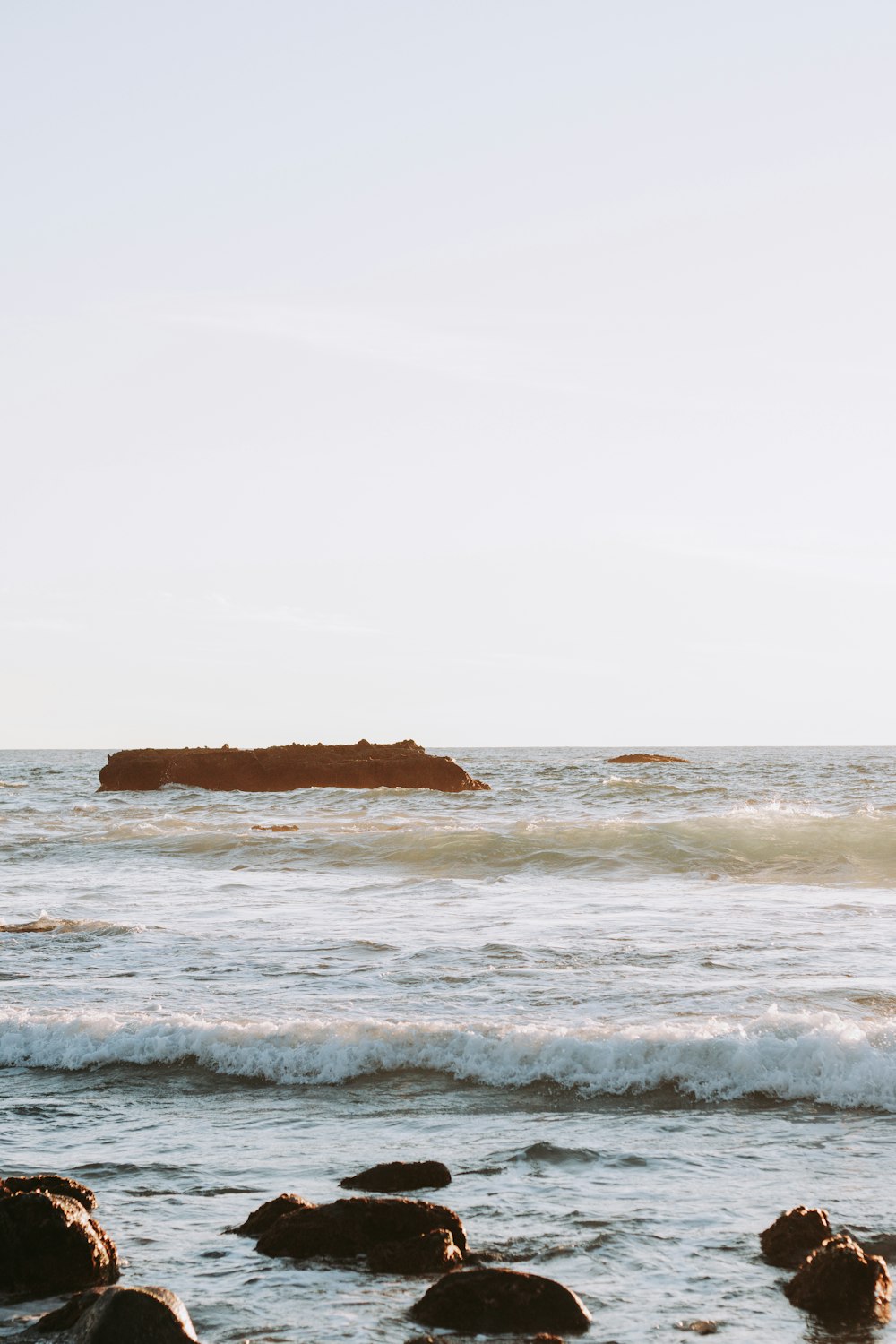 brown rock formation on sea during daytime