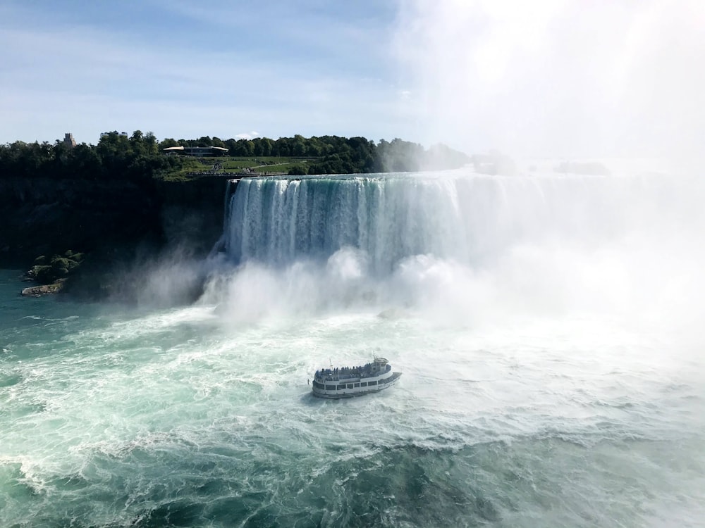 white and black ship on water falls during daytime