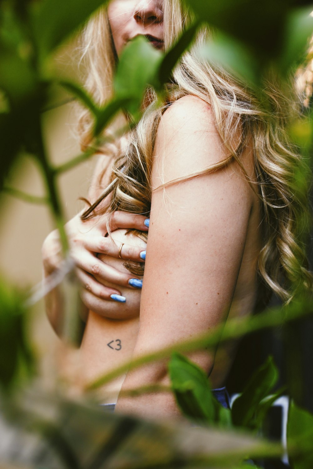 woman with brown hair covering her face