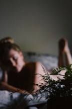 woman lying on white bed