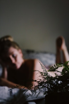 woman lying on white bed