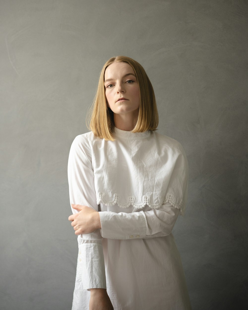 woman in white long sleeve shirt standing