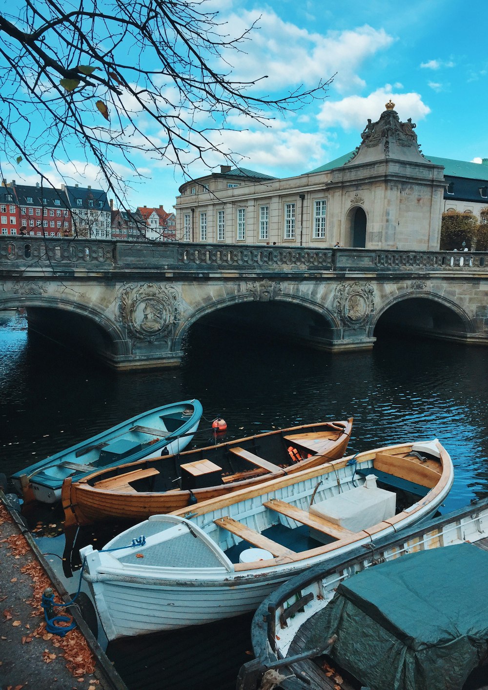 white and brown boat on river near bridge